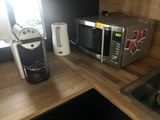 a microwave and a coffee maker on a kitchen counter