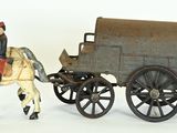 a figurine of a man riding on a horse drawn carriage