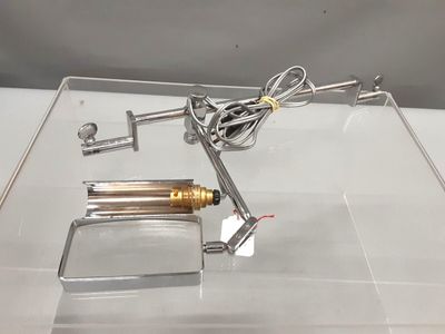 a metal object on display on a clear surface