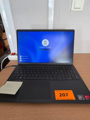 a laptop computer sitting on a desk with a price tag on it