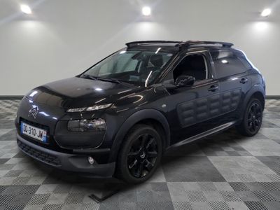 the black car is parked on a checkered floor in the garage