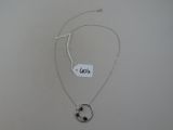 silver plated necklace with a black star and a circle pendant