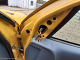 a yellow car door with the door handle open
