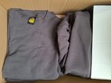 a box with two shirts in it and a box with a book