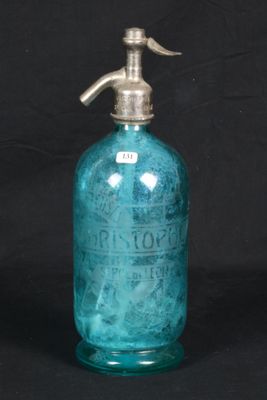 an old blue glass bottle with a metal pump on a black background