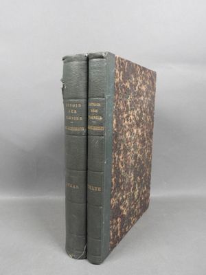two books sitting on top of each other on a white surface