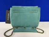 a green purse with a chain hanging from it ' s side