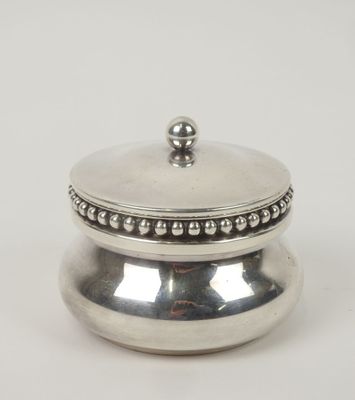 a silver plated box with a beaded lid on a white background