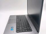 a laptop computer sitting on a table with a keyboard