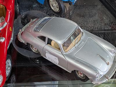 two toy cars that are on display in a glass case