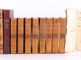 plusieurs vieux livres sont alignés sur une surface blanche