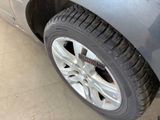 a close up of a tire on a car in a garage