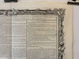 an old document on a table with a pen and paper clip