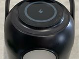 a black speaker with a white light on it