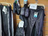 many pairs of pants hanging on a rack in a store