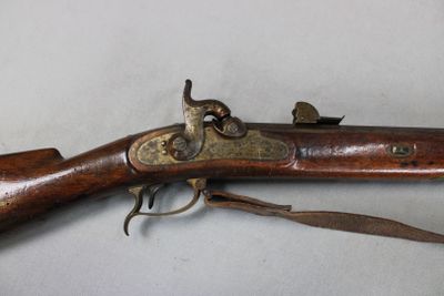 a close up of a rifle on a table with a white background