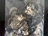 a bag full of assorted jewelry on a table