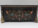 a black chest with a floral design on it