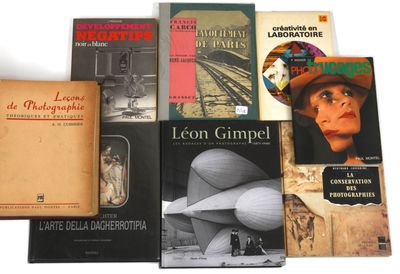 several books are stacked on top of each other on a white surface