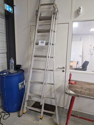a ladder leaning against a wall next to a blue barrel
