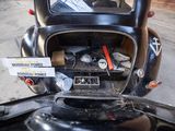 an old car with a lot of things in the trunk