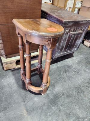 a wooden table with a wooden top in a room
