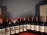 several bottles of red wine are lined up on a table