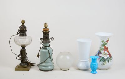 three different vases and a lamp on a table