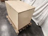 a wooden box sitting on a pallet in a warehouse