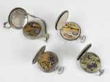 four different types of pocket watches are shown on a white surface