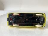 a close up of a yellow skateboard on a white surface