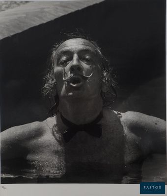 black and white photograph of a man with a bow tie in the water