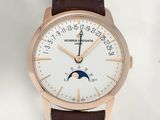 a watch with a white dial on a brown leather strap