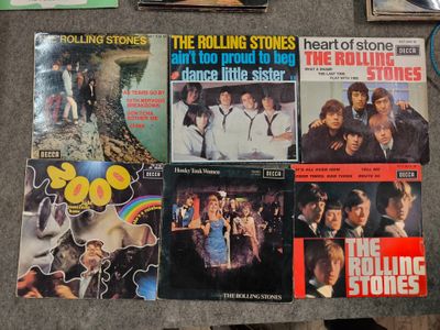 a table topped with a bunch of records on top of it