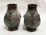 two vases that are sitting on a white surface