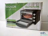 packaging of a small oven with a pizza in it sitting on a counter