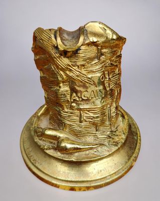 gold plated figurine of a man with a basket of bread