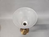 a white sink with a gold faucet in it