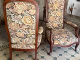 two chairs sitting next to each other in front of a fireplace