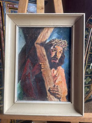 an oil painting of jesus carrying the cross on an easel