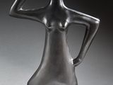 sculpture of a woman holding a bowl on her head