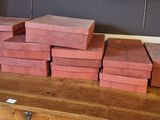 a stack of red boxes on a wooden table