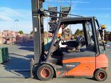 a forklift that is sitting in the middle of a parking lot