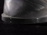a close up of a silver object on a black surface
