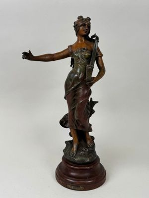 an antique bronze statue of a woman holding a bird on top of a wooden base