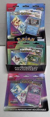three packs of pokemon trading cards in a display box