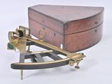 a small wooden box and a brass sexet on a stand