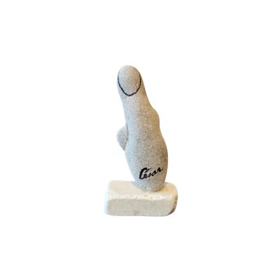 a small statue of a seal sitting on a rock