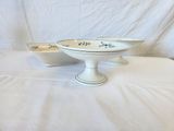 two bowls sitting on a table with a white cloth