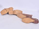 three pairs of shoes that are laying on the ground